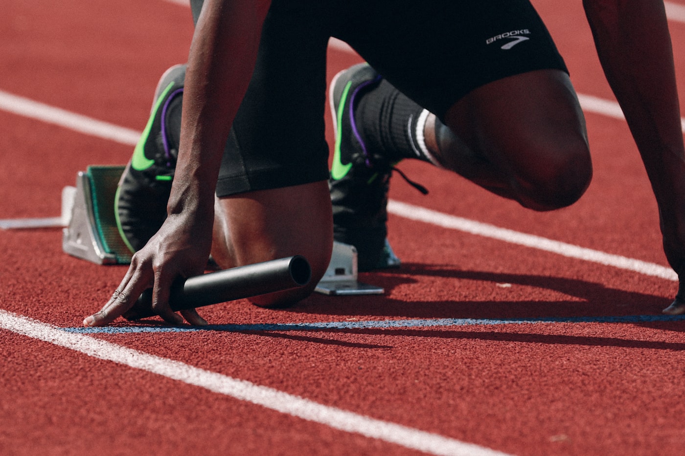 Athlete running on a track, representing HYROX training ahead of the 2027 race season