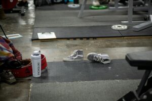 Pair of athletic shoes on a gym floor, representing the best HYROX shoes for 2026
